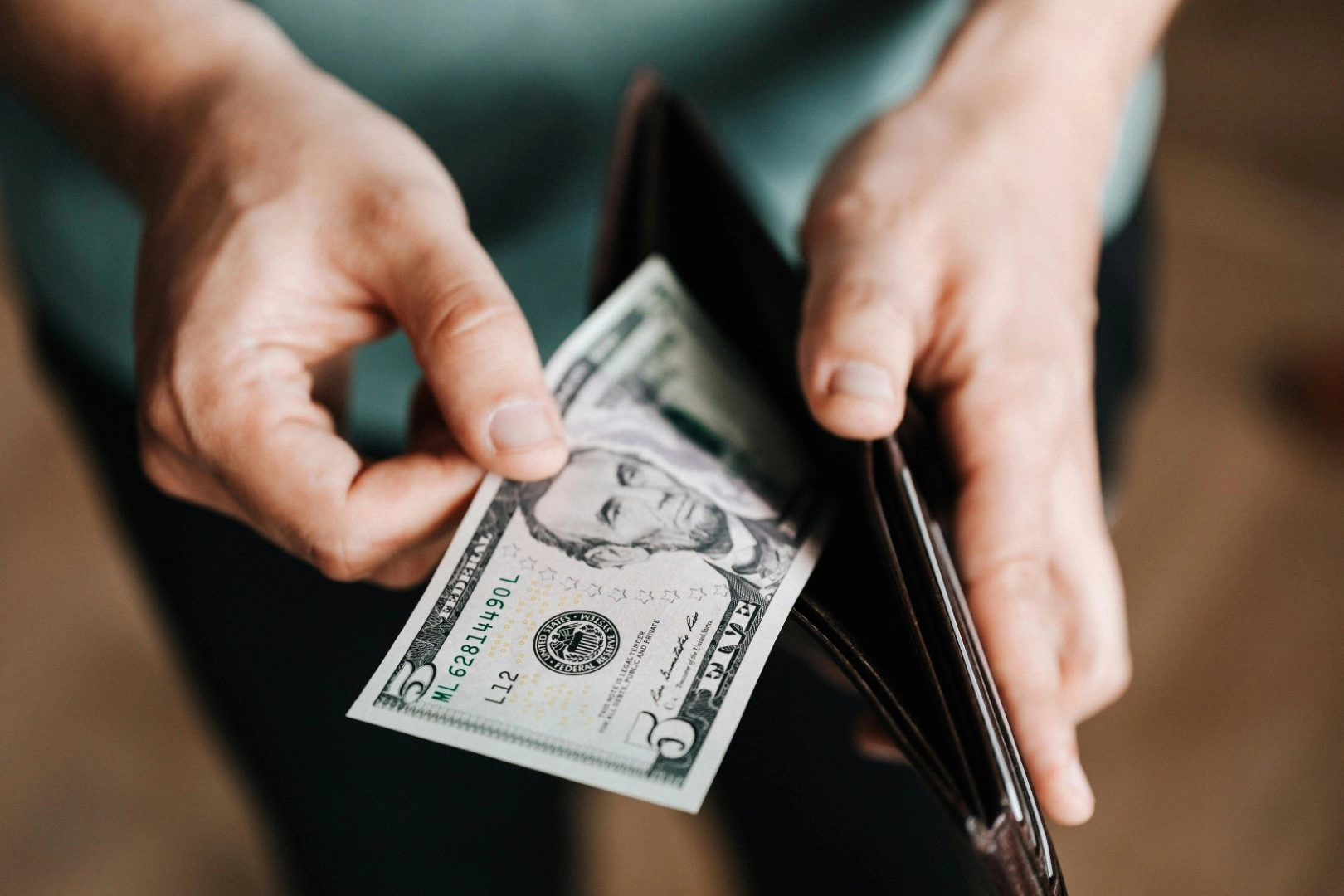 5 dollar bill leaving wallet